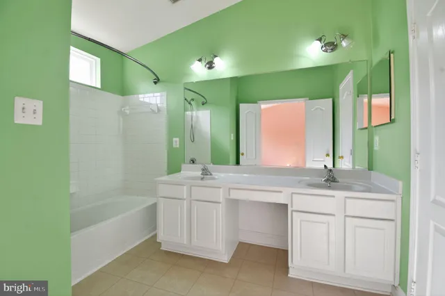 a bathroom with a double vanity sink and a mirror