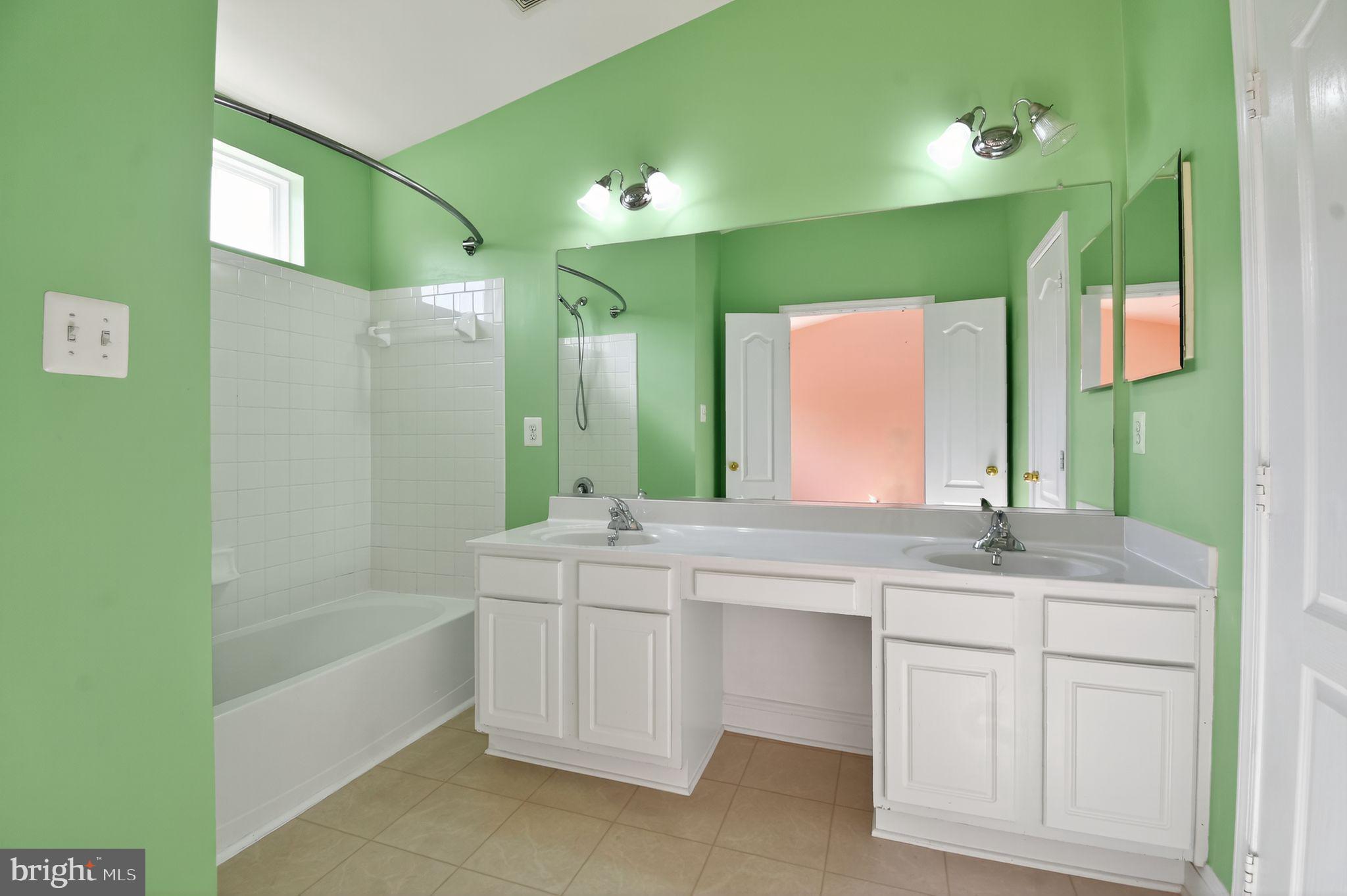 16567 Bramblewood Lane Woodbridge, VA 22191 - Photo 11 of 15 a bathroom with a double vanity sink and a mirror