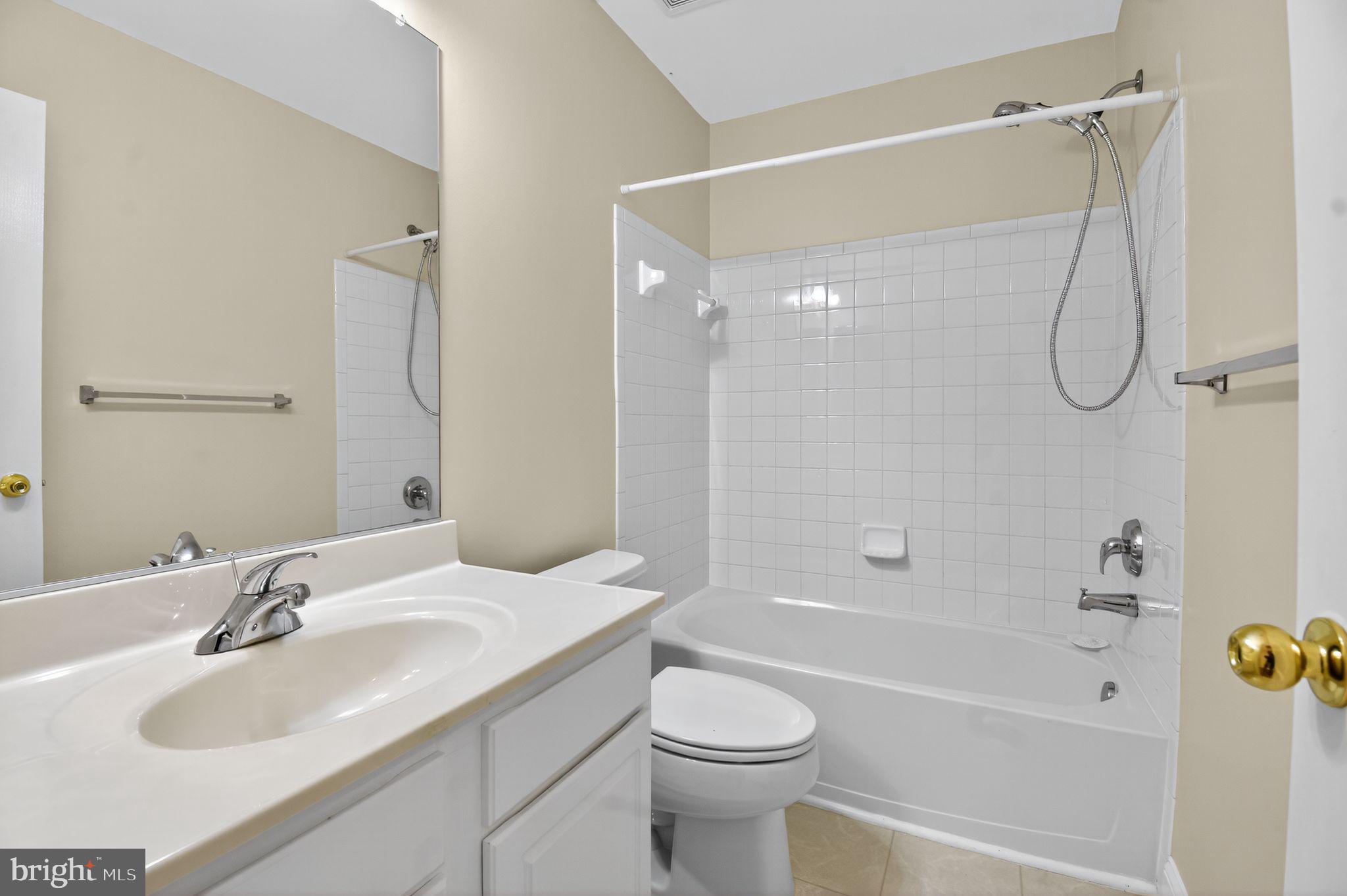 16567 Bramblewood Lane Woodbridge, VA 22191 - Photo 12 of 15 a bathroom with a granite countertop sink a toilet and shower