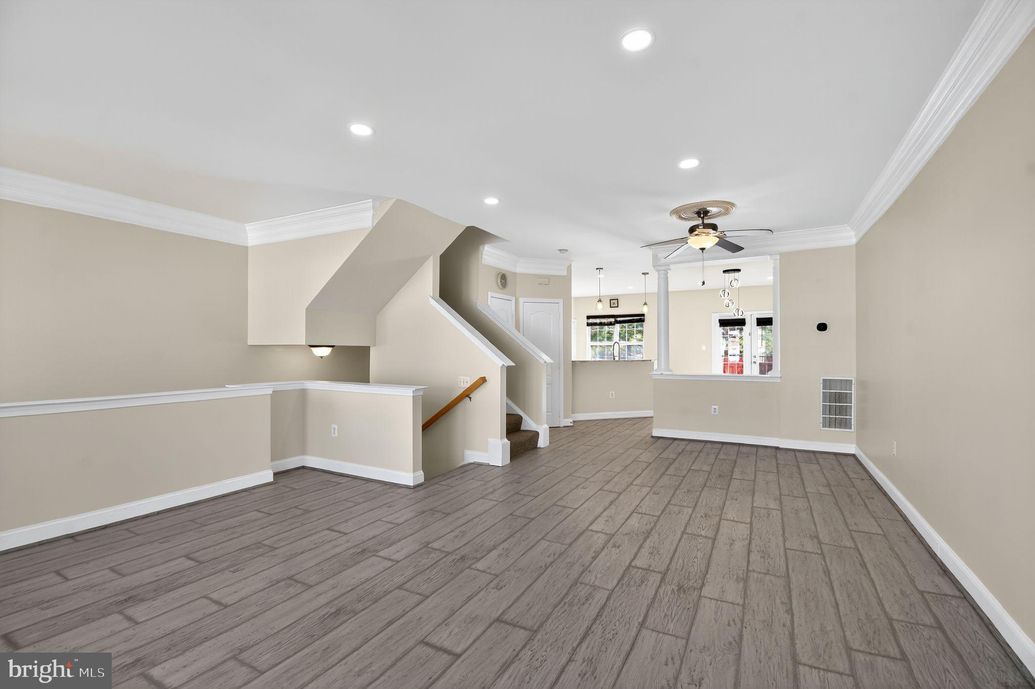 16567 Bramblewood Lane Woodbridge, VA 22191 - Photo 2 of 15 a view of an empty room with wooden floor and stairs
