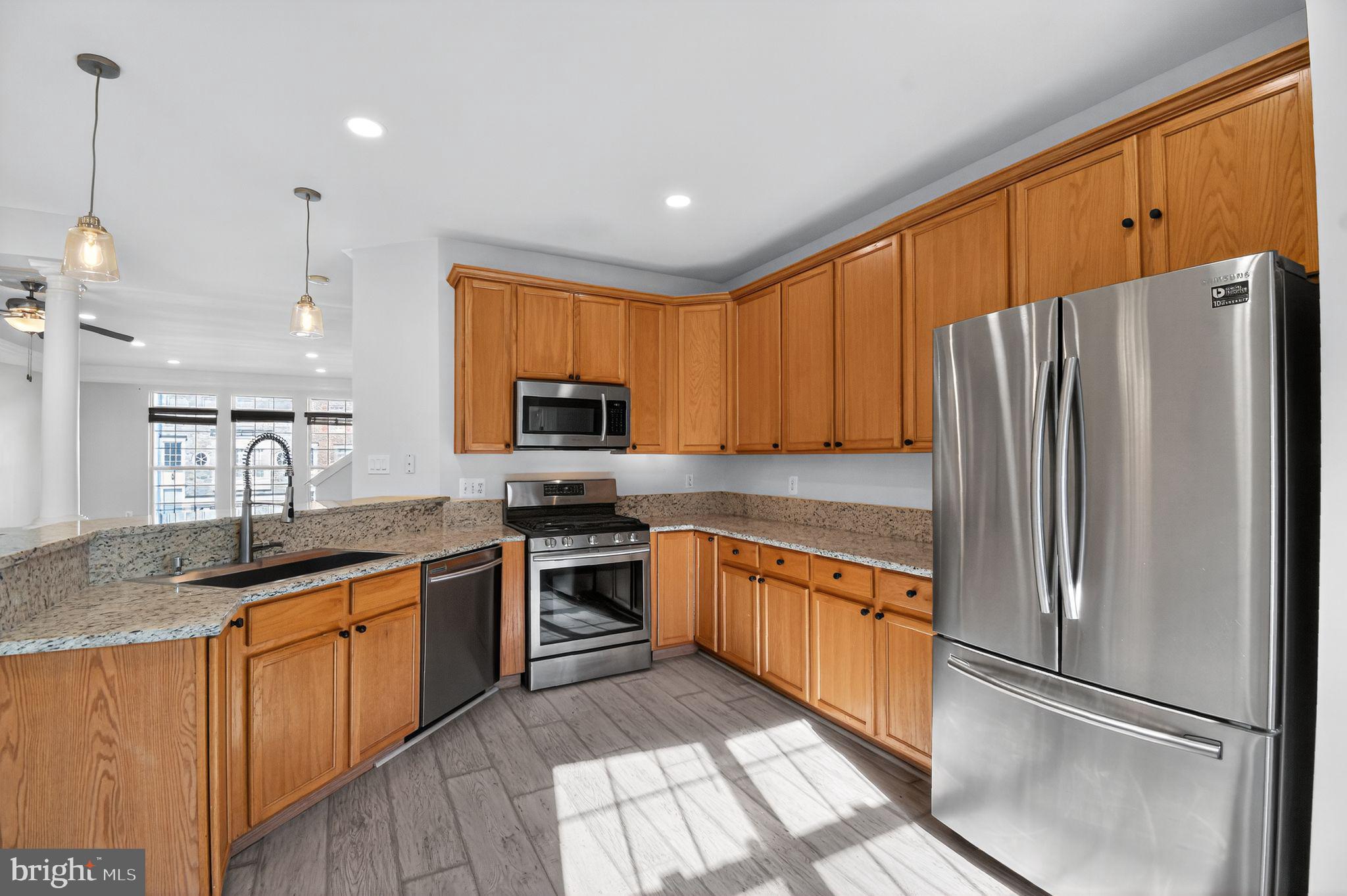 16567 Bramblewood Lane Woodbridge, VA 22191 - Photo 5 of 15 a kitchen with stainless steel appliances granite countertop a refrigerator a sink dishwasher a stove and a refrigerator