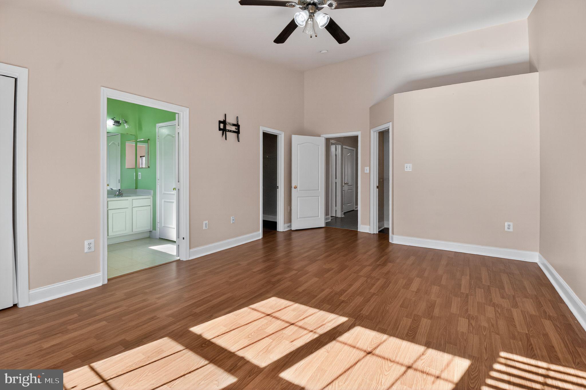 16567 Bramblewood Lane Woodbridge, VA 22191 - Photo 6 of 15 an empty room with wooden floor and ceiling fan