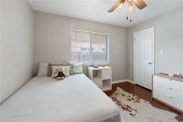 a bedroom with a bed and a table in it