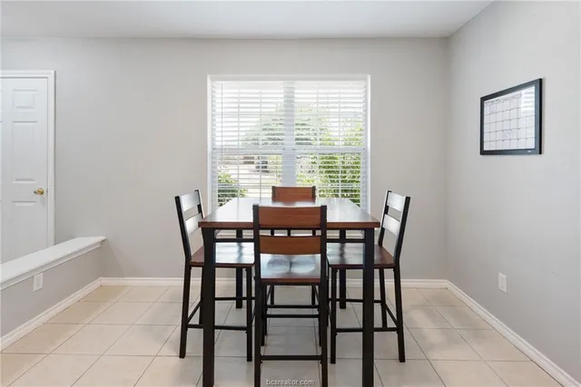 a dining room with furniture and window