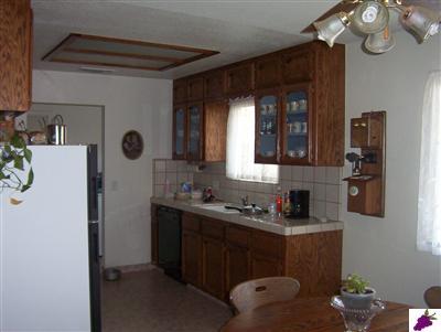 20945 Loper Valley Road Prather, CA 93651 - Photo 3 of 8 Kitchen with oak, glass front cabinets, tile counters, very clean