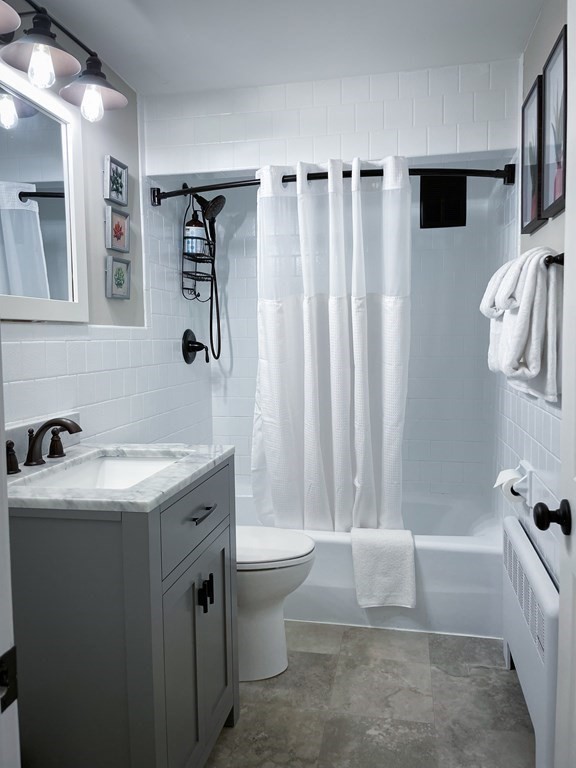 83 Rockridge Road Waltham, MA 02453 - Photo 14 of 16 a bathroom with a sink toilet and shower