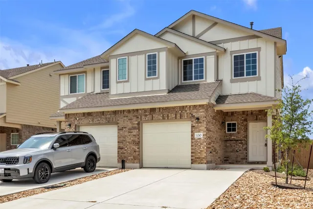 a front view of a house with parking
