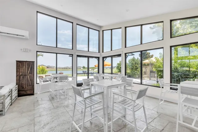 a room with lots of furniture and a large window