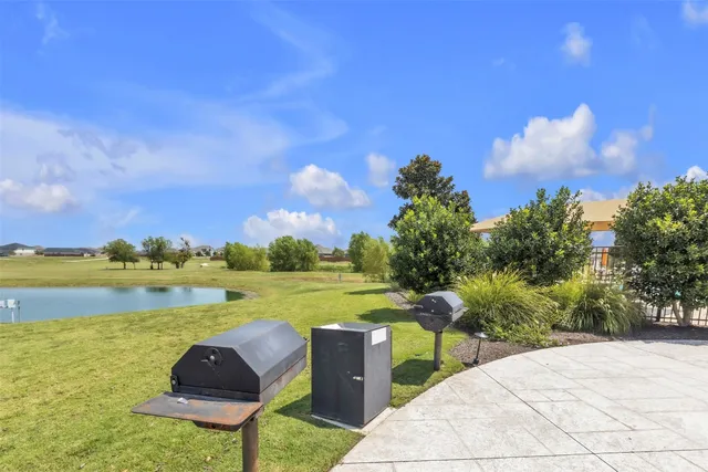 a view of a lake with a garden and a houses