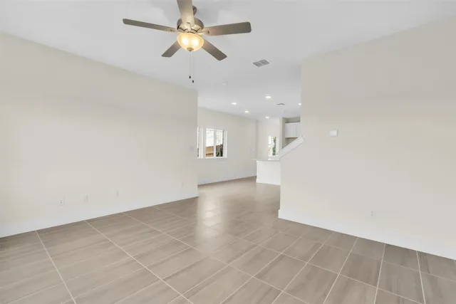 an empty room with a empty space and a ceiling fan