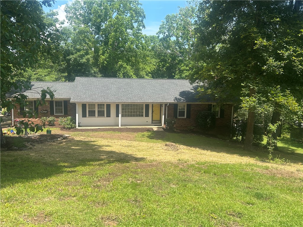 418 Saluda Road Williamston, SC 29697 - Photo 1 of 40 A classic brick and siding home, shaded by mature trees, welcomes with a vibrant yellow front door.