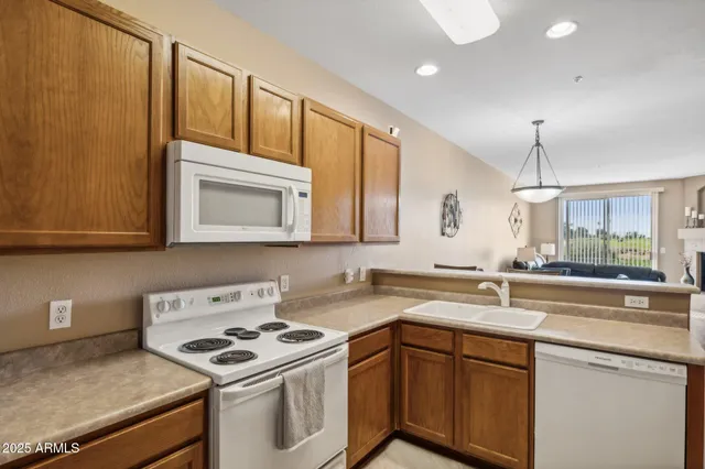 a kitchen with stainless steel appliances a sink stove and cabinets