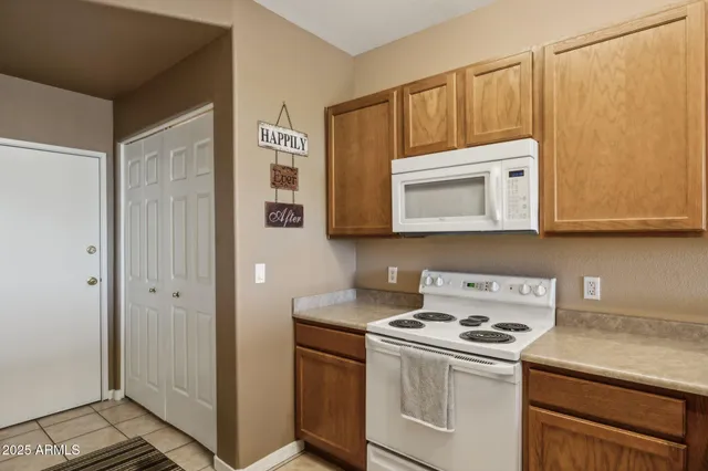 a kitchen with stainless steel appliances white cabinets and a stove top oven
