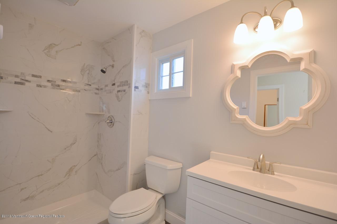 31 Berkshire Road Whiting, NJ 08759 - Photo 14 of 25 a bathroom with a sink a toilet and a mirror