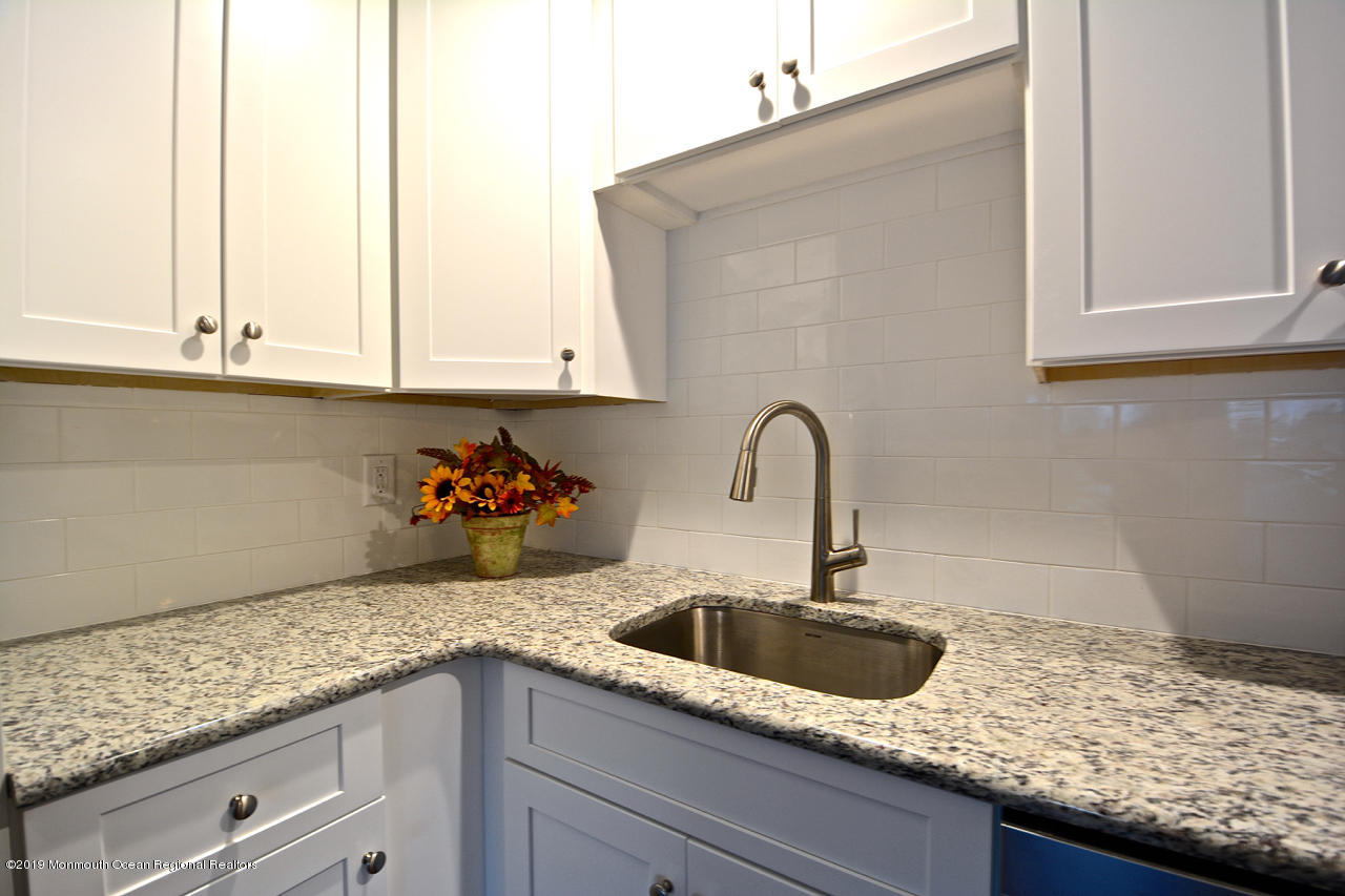 31 Berkshire Road Whiting, NJ 08759 - Photo 3 of 25 a kitchen with granite countertop white cabinets and a sink