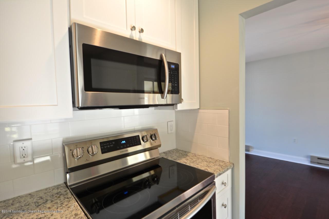 31 Berkshire Road Whiting, NJ 08759 - Photo 5 of 25 a kitchen with a stove and a microwave