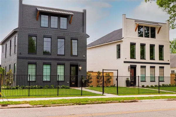 a view of a brick building next to a yard