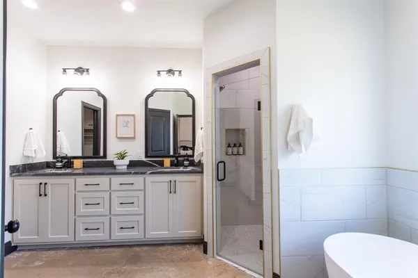 a spacious bathroom with a granite countertop sink mirror and toilet