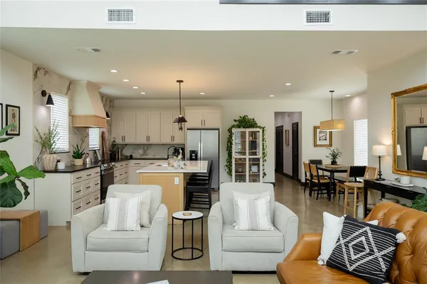 a living room with furniture kitchen and a table