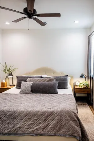 a bedroom with a bed and ceiling fan
