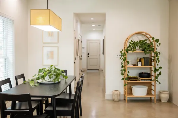 a view of a dining room with furniture and a window