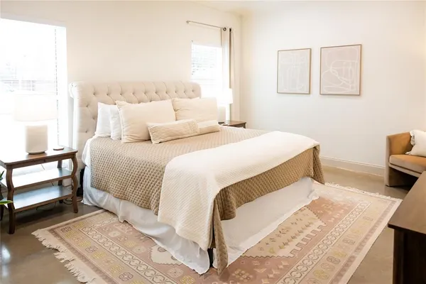 a bedroom with a bed and a table