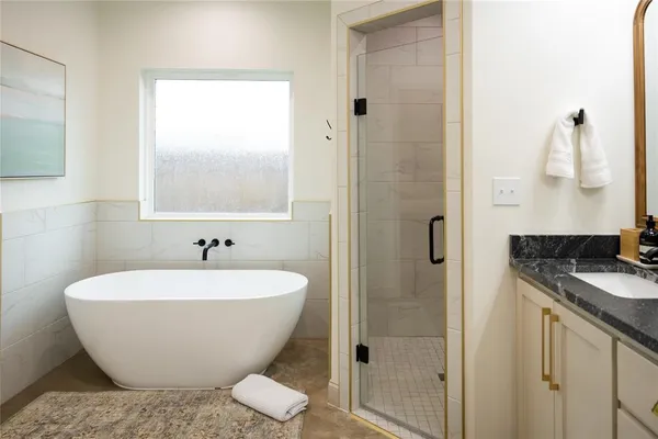 a white bath tub sitting next to a white sink