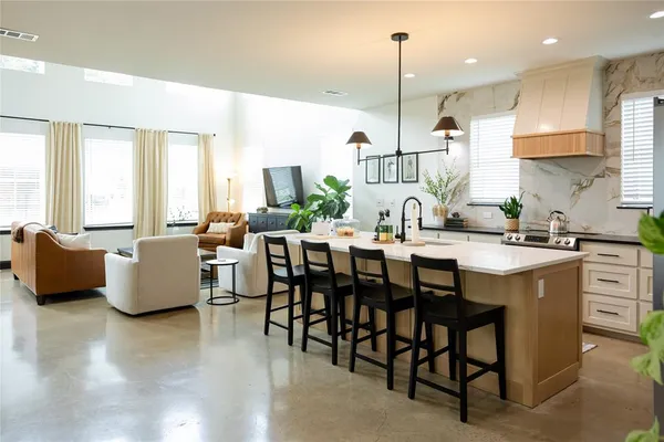a large kitchen with a table and chairs