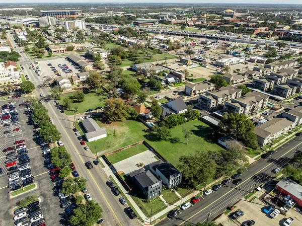 an aerial view of residential houses with outdoor space