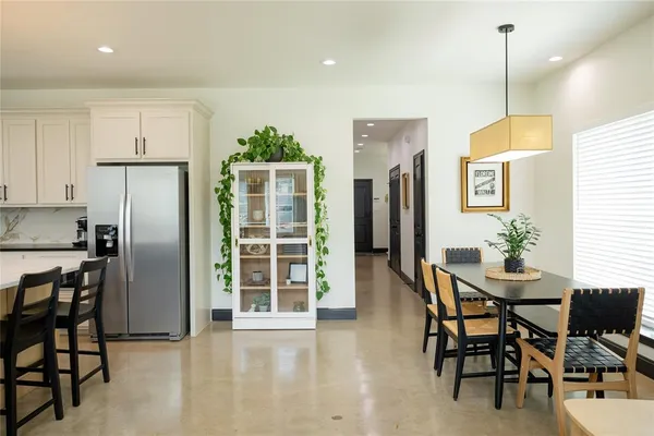 a dining room with furniture and window