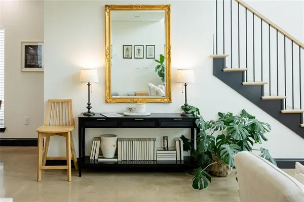 a living room with furniture and a potted plant