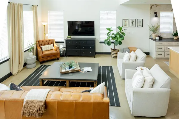 a living room with furniture fireplace and flat screen tv