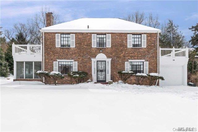 54 Andrew Road Manhasset, NY 11030 - Photo 1 of 1 a view of a house with a yard covered in snow