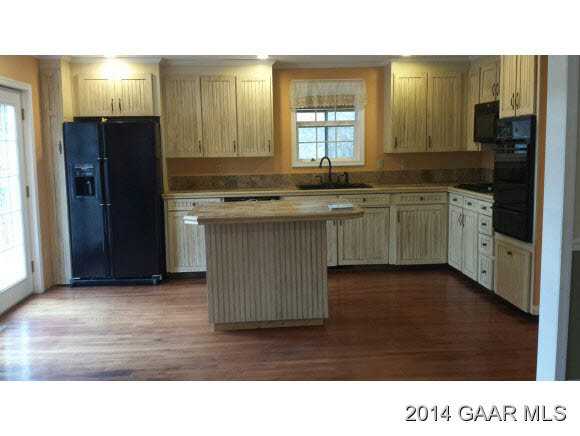269 Dabneys Road Raphine, VA 24472 - Photo 17 of 22 a kitchen with a sink and a refrigerator