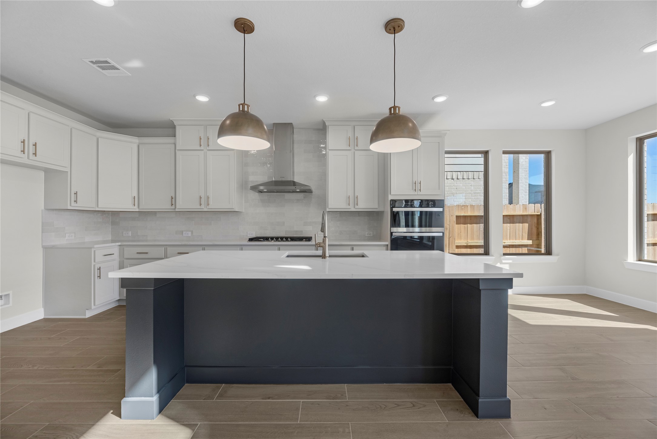 5023 Nesbit Path Rosenberg, TX 77471 - Photo 5 of 25 a kitchen with kitchen island a sink stainless steel appliances and cabinets