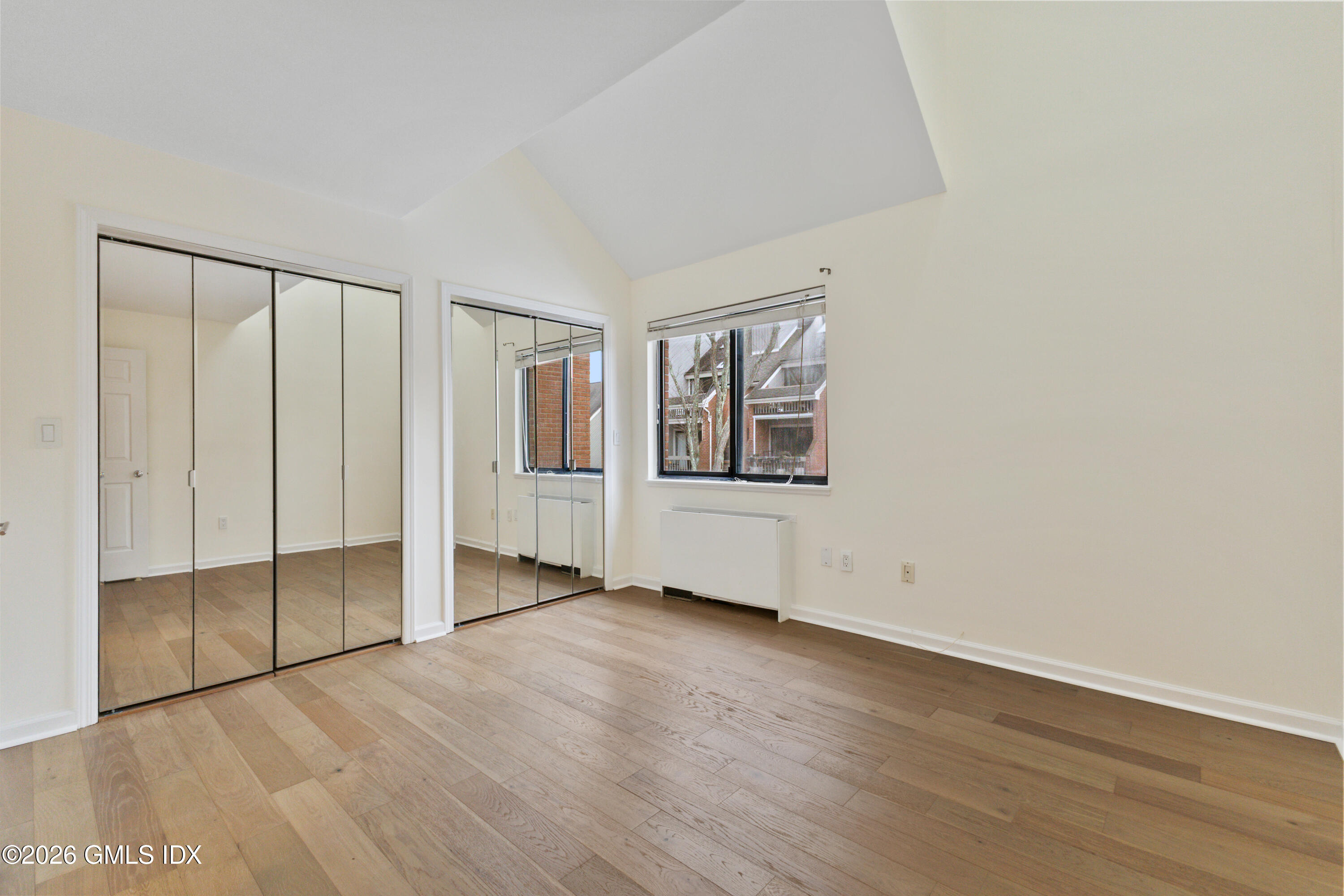 15 River Road, Unit 210 Cos Cob, CT 06807 - Photo 21 of 23 an empty room with wooden floor and windows