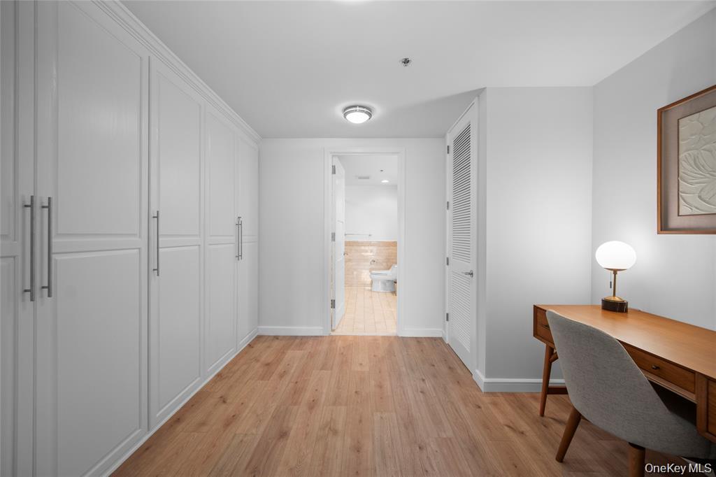 1 Renaissance Square, Unit 10F White Plains, NY 10601 - Photo 14 of 27 a view of a room with wooden floor cabinet and a bathroom