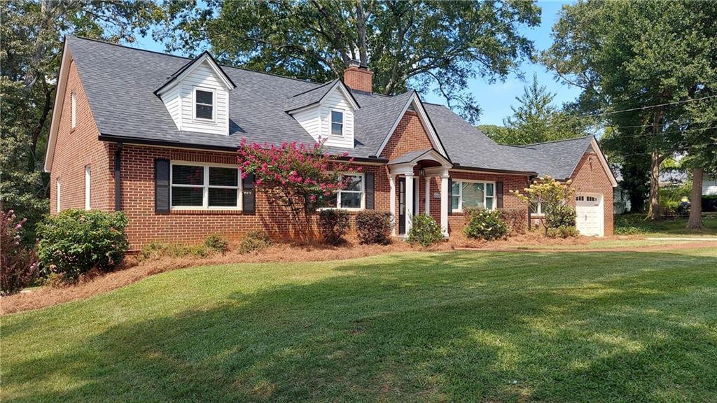 650 Blue Ridge Avenue Gainesville, GA 30501 - Photo 1 of 1 a front view of a house with a garden and trees