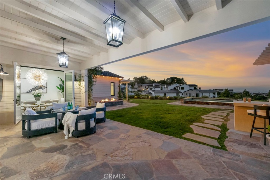 5 Rancho Elastico Road Rolling Hills Estates, CA 90274 - Photo 45 of 48 a view of a patio with couches table and chairs and potted plants