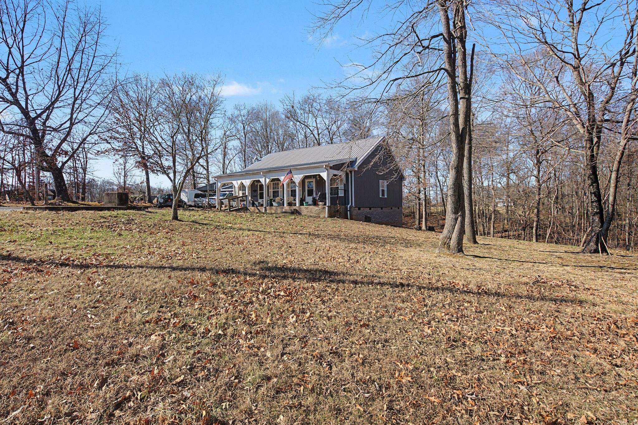 1075 Coker Ford Road Portland, TN 37148 - Photo 2 of 35 a front view of a house with a yard covered with snow
