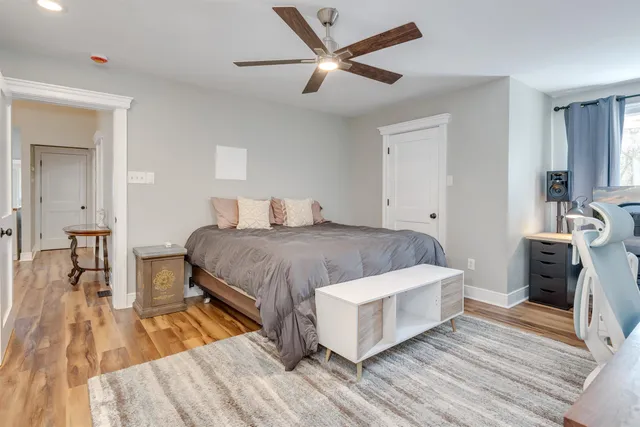 a spacious bedroom with a bed and a table