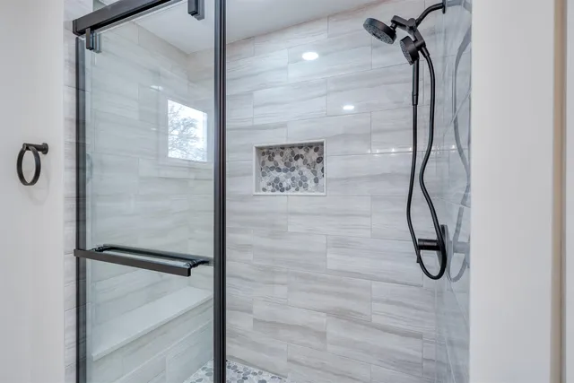 a bathroom with a glass shower door