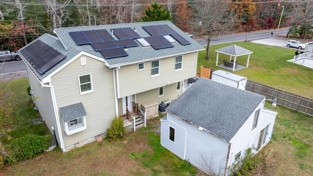 an aerial view of a house with a yard table and chairs
