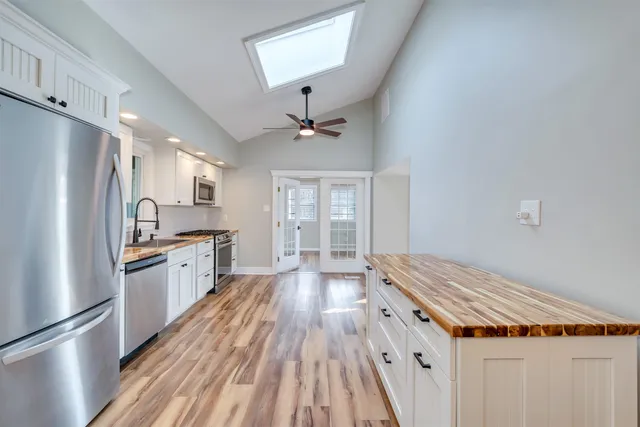 a kitchen with wooden floors and refrigerator