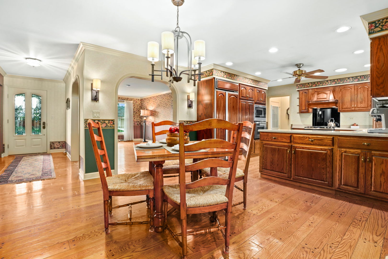 518 Northgate Road Lindenhurst, IL 60046 - Photo 12 of 35 a kitchen with stainless steel appliances kitchen island granite countertop a table chairs and a refrigerator