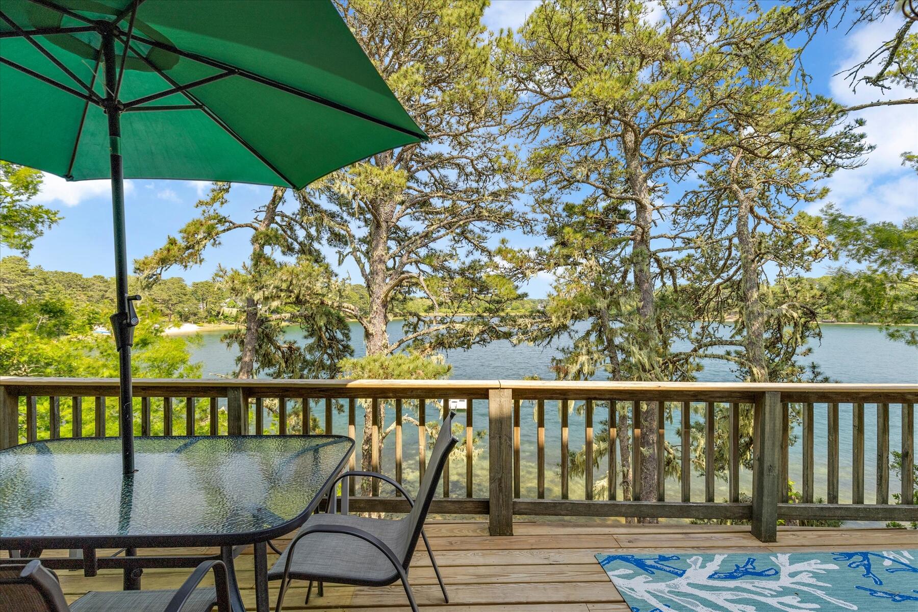 194 John Joseph Road Harwich, MA 02645 - Photo 22 of 87 a roof deck with table and chairs under an umbrella