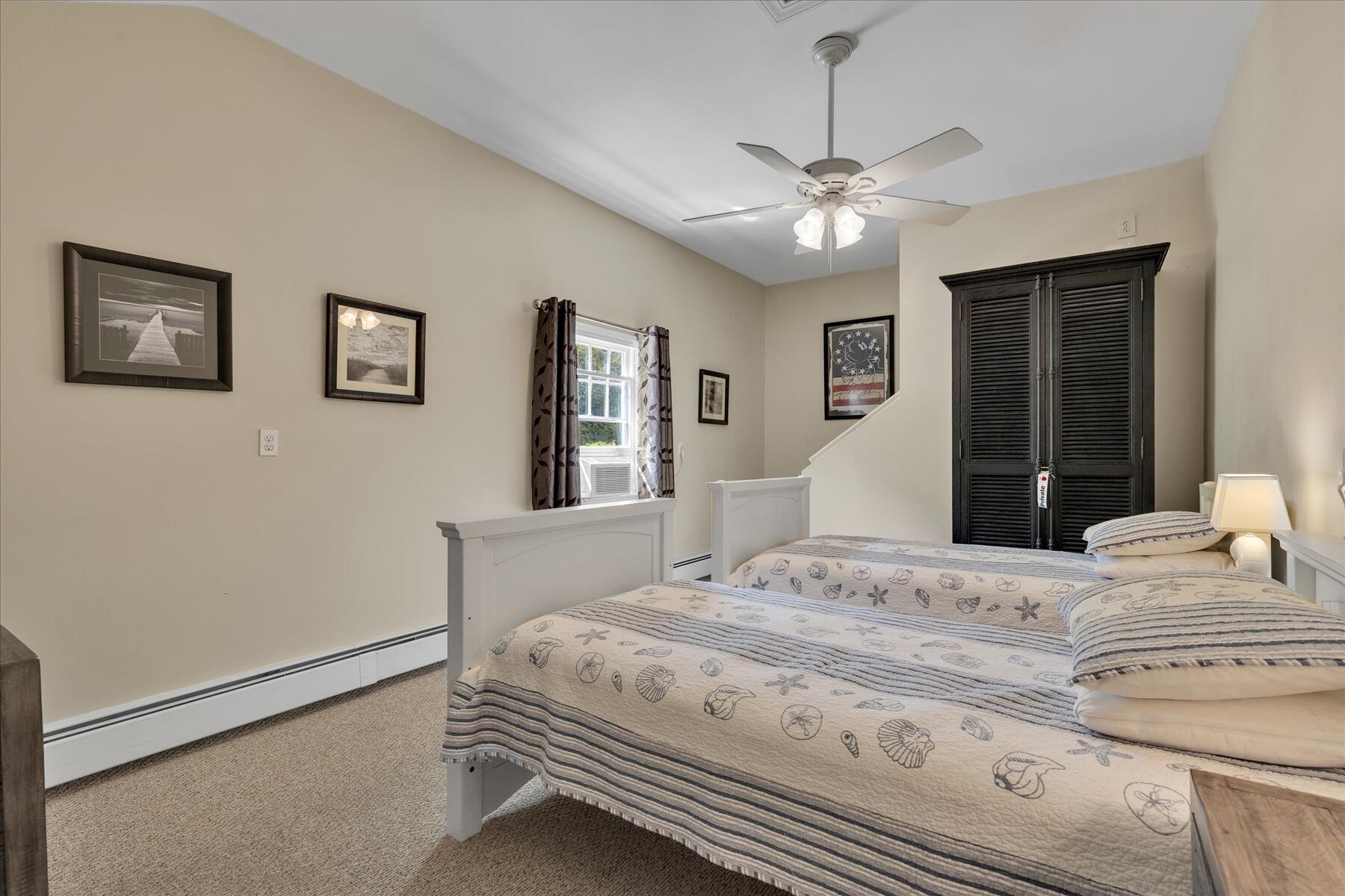 194 John Joseph Road Harwich, MA 02645 - Photo 35 of 87 a bedroom with a bed and a chandelier