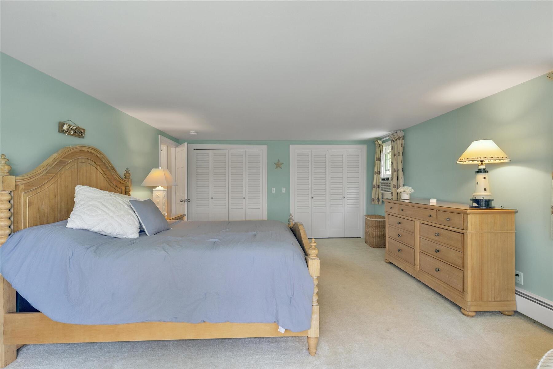 194 John Joseph Road Harwich, MA 02645 - Photo 41 of 87 a bedroom with a bed and a chandelier