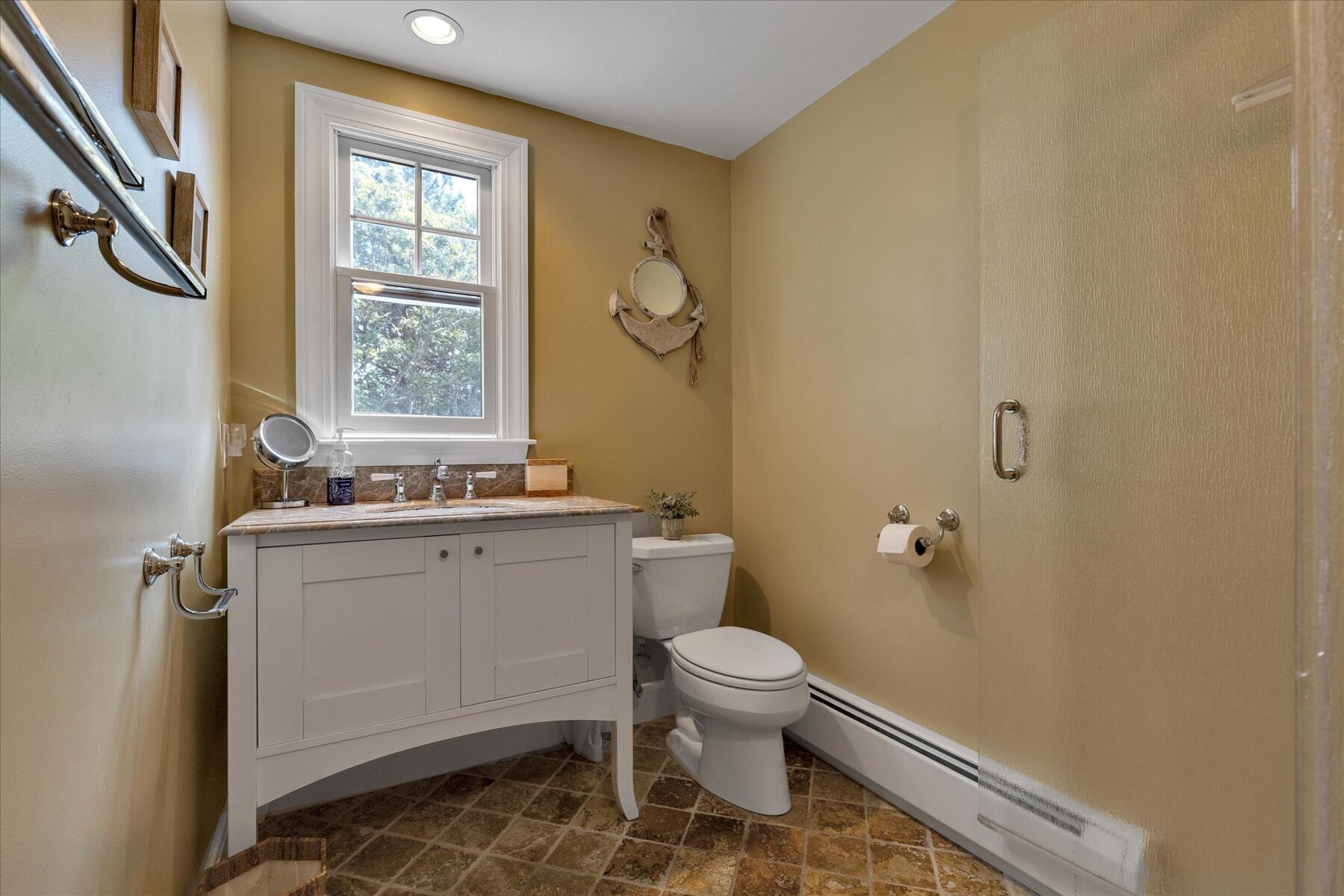194 John Joseph Road Harwich, MA 02645 - Photo 45 of 87 a bathroom with a granite countertop toilet a sink and a window