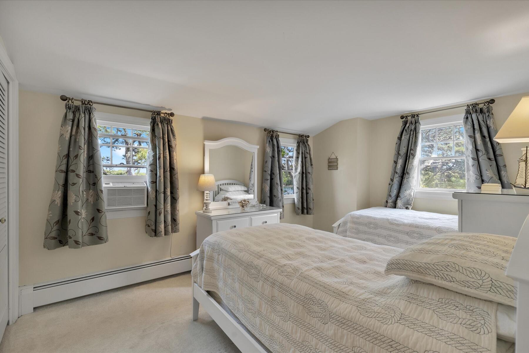 194 John Joseph Road Harwich, MA 02645 - Photo 47 of 87 a bedroom with a bed a mirror and windows